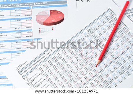 red pencil over financial documents