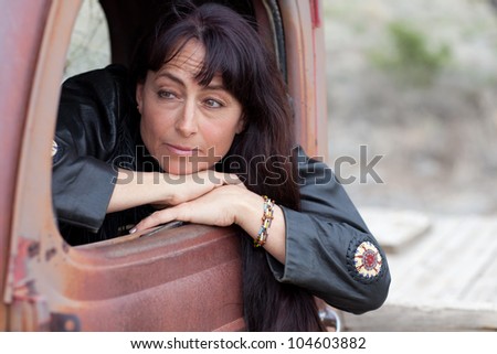 Beautiful Middle Aged Woman in a Vintage truck with a pensive look