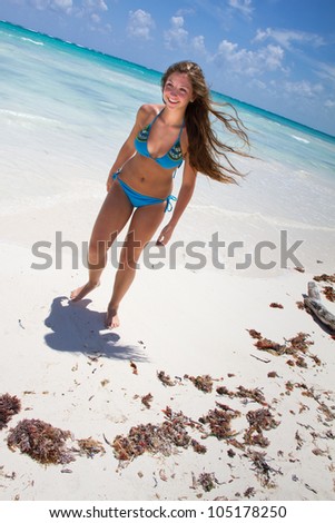 Young beautiful women in a Bikini on the sunny tropical beach