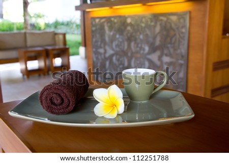 Welcoming guest to the spa with a warm towel, flower and cup of Tea