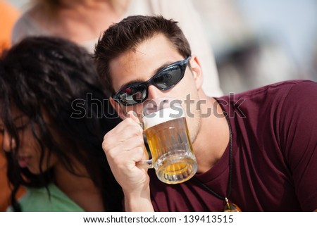 Attractive Man and woman with a beer at an outside cafe on the Beach in Venice California