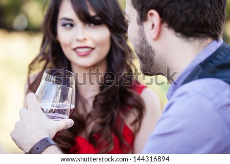 Happy Beautiful Young Couple toasting looking into each others eyes