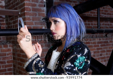 Pretty Asian Woman with Purple Hair fixing her Makeup in a mirror