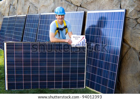 Close up of a Man in his forties overseeing a Solar Installation with Solar Panels behind him