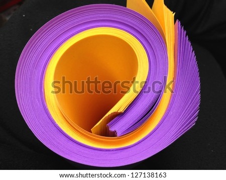 Yellow ,and Purple Rolled Papers on Black Background