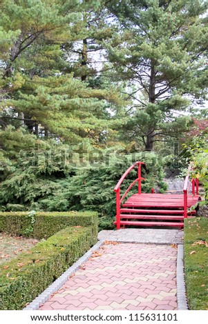 japanese zen garden with red bridge