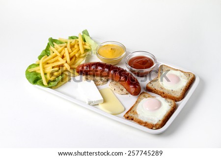smoked pork sausage grilled on a white plate with a nice toast bread and baked egg and two kinds of cheese with fries and lettuce and red tomato ketchup and yellow mustard
