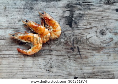 shrimp - prepared fresh seafood scampi on natural organic rustic wooden background