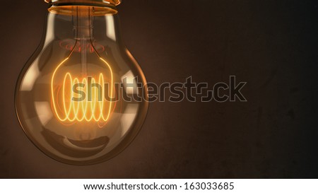 Close up of an illuminated vintage hanging light bulb over dark background