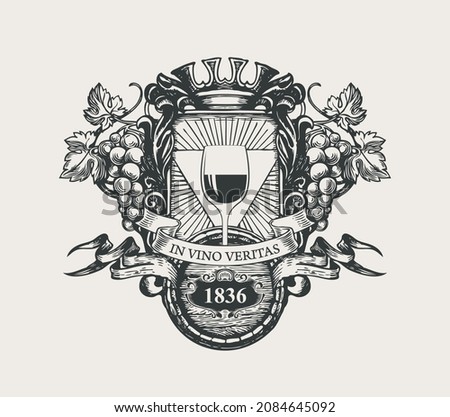 Ornate vector banner in form of coat of arms with a glass of wine, bunches of grapes, a crown, wooden barrel, ribbons and the words In vino veritas. Hand-drawn black-white illustration in retro style