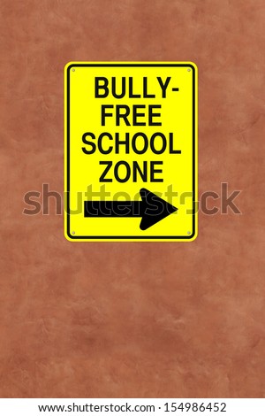A modified one way street sign pointing to a bully-free school zone