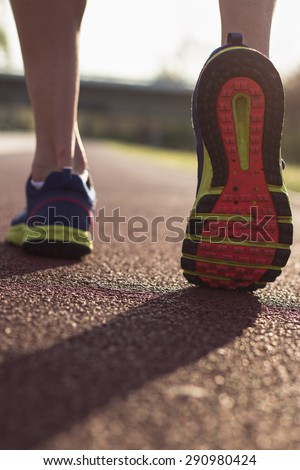 Male running outdoor, runner feet with close up on a shoe.