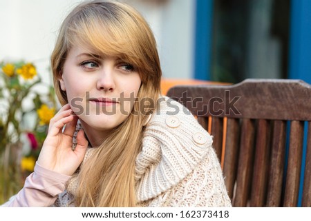 Pretty young woman,late teen girl,with very long blond hair,outdoor candid portrait