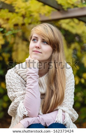 Pretty young woman,late teen girl,with very long blond hair,outdoor candid portrait
