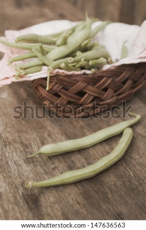 French bean pod on wooden table.