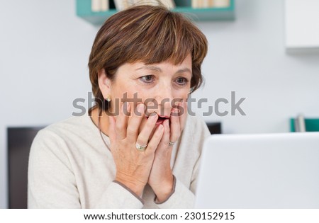 Surprised woman looking at computer screen