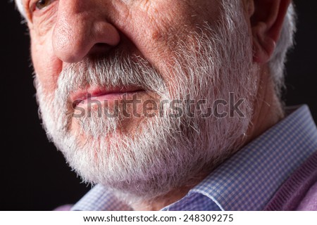 Senior man./ Closeup of white beard over a black background