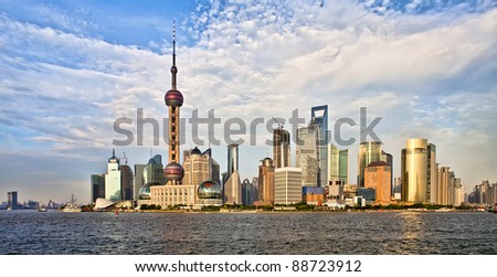 Panoramic view on modern Shanghai architecture skyline of Pudong district at sunset from the Bund on Huangpu river, China