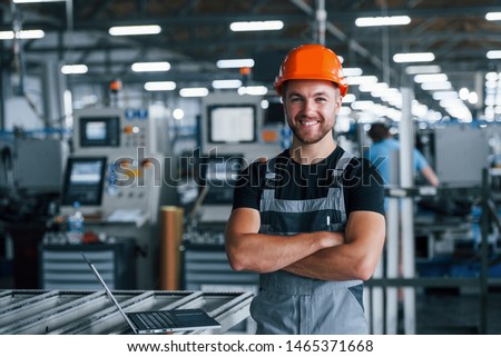 Similar – Image, Stock Photo Male warehouse employee in uniform standing near rack in warehouse