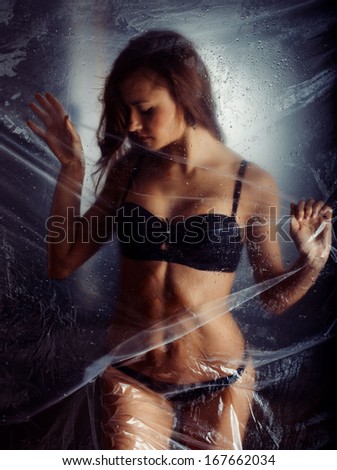 Beautiful woman behind the shower curtain relaxing
