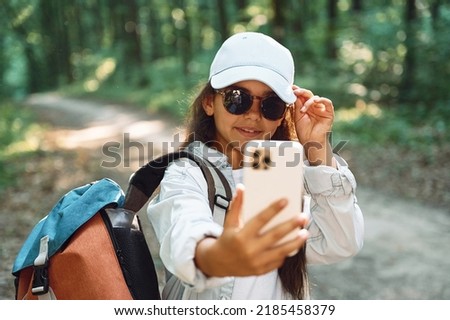 Similar – Image, Stock Photo Casual tourist making photo on smartphone of nature