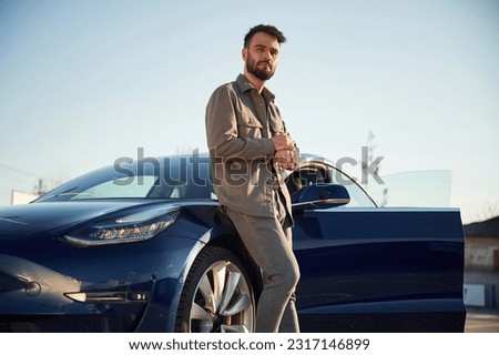 Similar – Image, Stock Photo Stylish man standing near wall