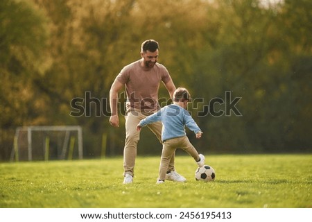 Similar – Image, Stock Photo Ethnic father playing with child on ground