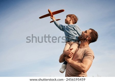 Similar – Image, Stock Photo Ethnic father playing with child on ground