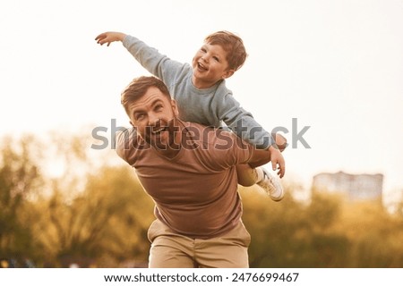 Similar – Image, Stock Photo Father with sons and ball