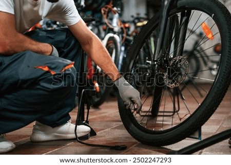 Similar – Foto Bild Konzentrierter Mann repariert Fahrrad in Garage