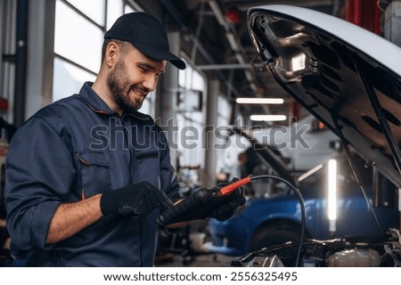 Similar – Image, Stock Photo Busy male mechanic repairing motorcycle seat in workshop