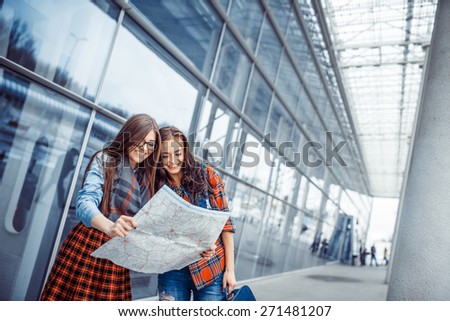 Two girlfriends looking for a route map.Art processing and retouching photos special.