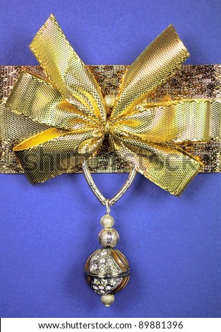 Blue wrapped gift with a golden bow and jewel