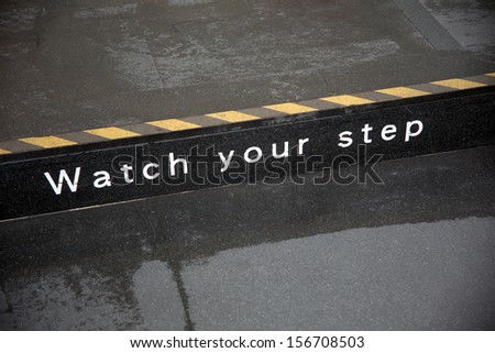 watch your step sign on road side