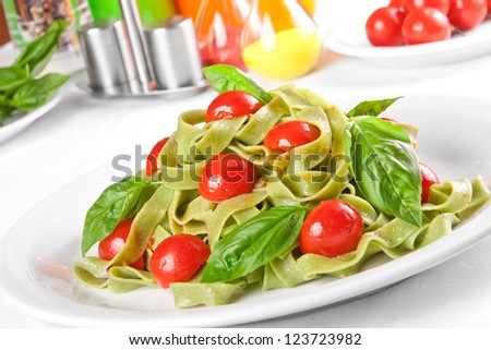 Pasta tagliatelle with pesto sauce and cherry tomato