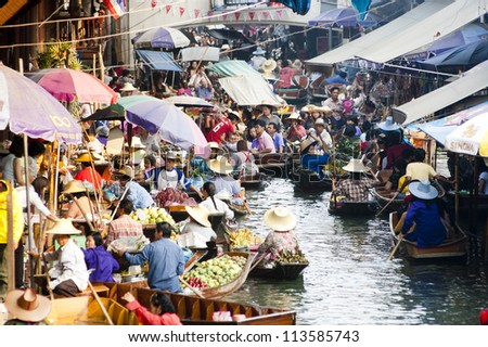 RATCHABURI, THAILAND - FEB 16: Locals travel on rowing boats, selling products  at Damnoen Saduak Floating Market on Feb 16, 2008 in Ratchburi, Thailand. The market is one of tourist spots in Thailand