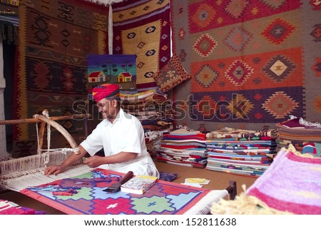 JODHPUR, INDIA - FEB 28: A craftsman uses a handloom to produce rugs on Feb 28, 2013 in Jodhpur, India. The handloom sector is known for its heritage and tradition of excellent craftsmanship of India.