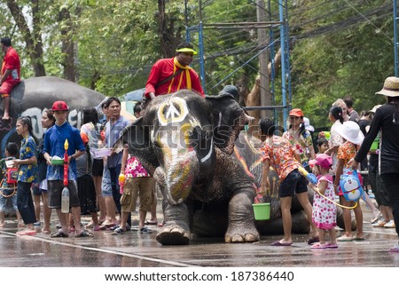 AYUTTHAYA, THAILAND - APR 13:  Revelers and elephants join in water splashing during Songkran Festival on Apr 13, 2014 in Ayutthaya, Thailand.  The festival has been observed as New Year for Thais.