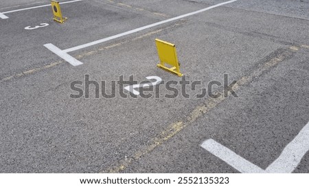 Similar – Image, Stock Photo Two asphalt parking spaces in front of a colourful concrete wall and the shadow of a railing