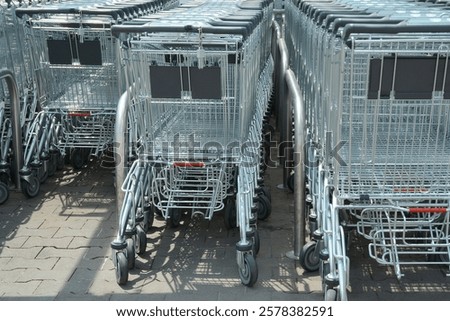 Similar – Image, Stock Photo Shopping carts arranged in the parking and entrance area of a giant warehouse supermarket, on the outskirts of Zaragoza city, Spain.