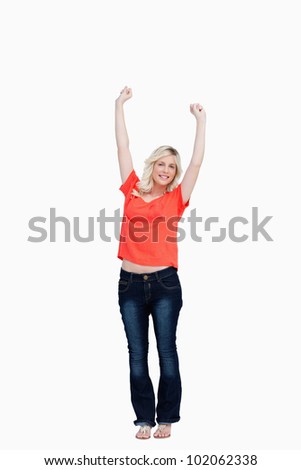 Teenager raising her arms above the head against a white background