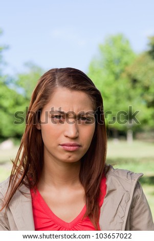 Woman looking directly in front of her with a stern expression on her face