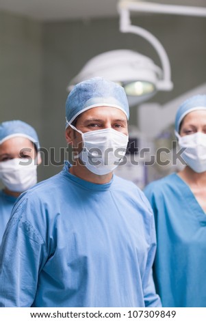 Medical team wearing mask and cap in operating theatre