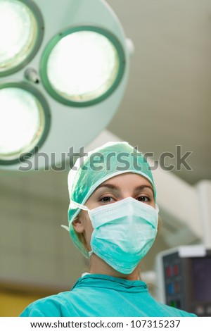 Surgeon under surgical lights in a surgical room
