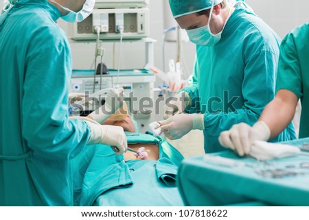 Surgeon operating a patient in an operating theater in a hospital
