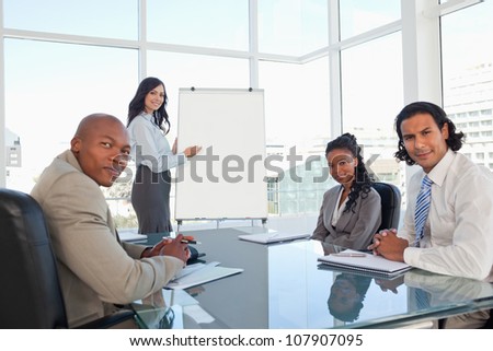 Serious business team almost smiling during a presentation in a meeting room