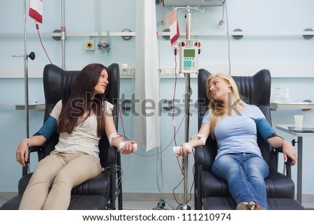Patient talking to another patient in hospital ward