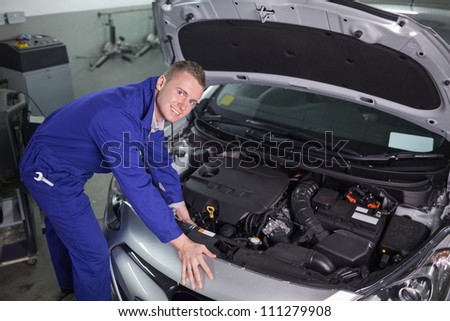 Mechanic repairing an engine of car in a garage