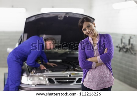 Front view of a smiling client looking at camera in a garage