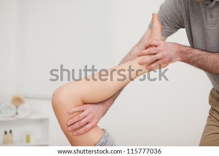 Leg being stretched by a doctor in a physio room